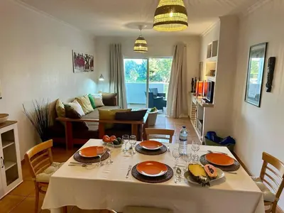 a kitchen and living room with a table and chairs at Monteverde Kulle by FHR piscina & parking in Vilamoura