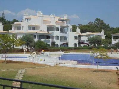 a large white building with a swimming pool in front of it at Monteverde Kulle by FHR piscina & parking in Vilamoura