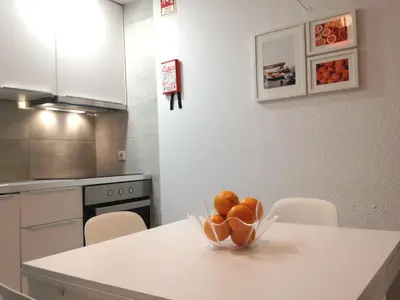 a bowl of oranges sitting on a table in a kitchen at Casa Montechoro in Albufeira