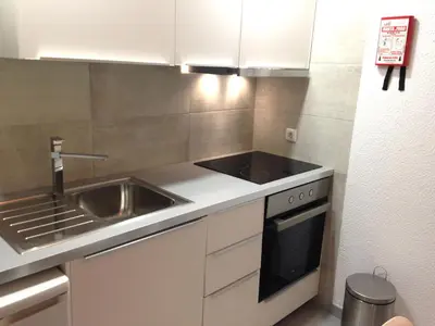 a small kitchen with a sink and a stove at Casa Montechoro in Albufeira