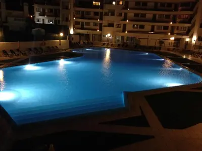 a large swimming pool in a building at night at Casa Montechoro in Albufeira