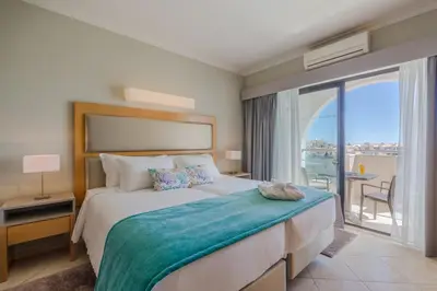 a bedroom with a large bed with a large window at The Navigator - Solaqua in Albufeira