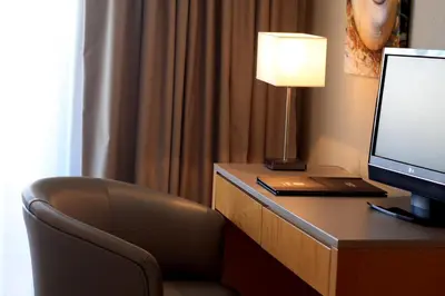 a hotel room with a desk with a monitor and a chair at The Navigator - Solaqua in Albufeira