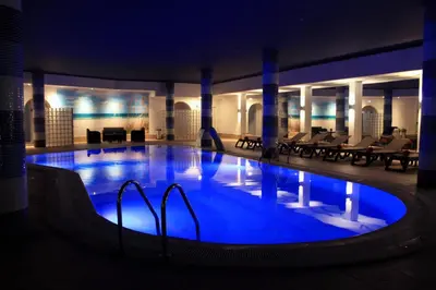 a swimming pool at a resort with chairs and a building at The Navigator - Solaqua in Albufeira