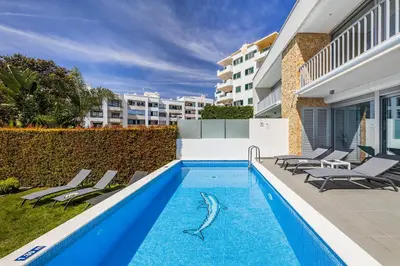 a swimming pool with a shark stencil on the side of a building at Design Villa Pascoal in Albufeira