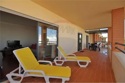 two yellow chairs in a room with a balcony at Corcovada, Albufeira, Algarve in Albufeira