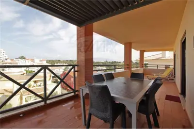 a table and chairs on a balcony with a view at Corcovada, Albufeira, Algarve in Albufeira