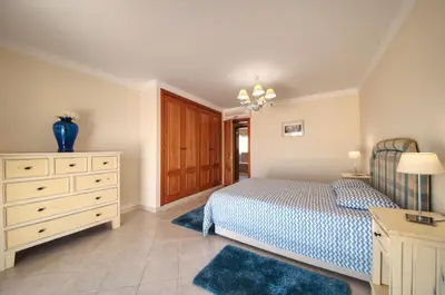 a bedroom with a bed and a dresser and a drawer at Spacious house with private pool in Albufeira in Albufeira