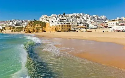 a view of a beach with a town in the background at Spacious house with private pool in Albufeira in Albufeira