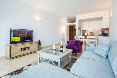 a living room with a couch and a tv at Camilla apartment in Albufeira