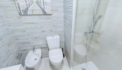 a white bathroom with a toilet and a sink at Stay Inn Albufeira - 303B Apartment in Albufeira