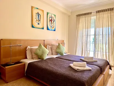 a bedroom with two beds with towels on them at Holiday Duplex Alto dos Salgados in Albufeira