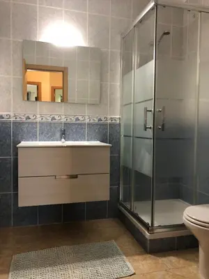 a bathroom with a shower and a sink and a toilet at Holiday Duplex Alto dos Salgados in Albufeira
