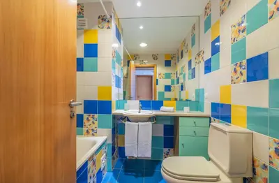 a colorful bathroom with a toilet and a sink at Apartamentos da Orada by Garvetur in Albufeira