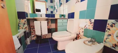 a bathroom with a toilet and a sink at Apartamentos da Orada by Garvetur in Albufeira