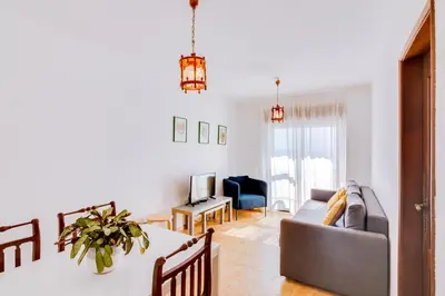 a living room with a couch and a table at AL - Apartamento Girassol in Quarteira