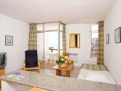a living room with a couch and a table at Apartamentos Edificio Albufeira - Alojamento Local in Albufeira