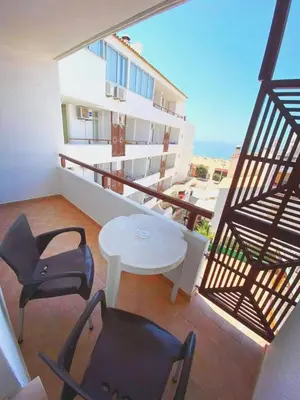 a balcony with a table and chairs on a building at Apartamentos Edificio Albufeira - Alojamento Local in Albufeira