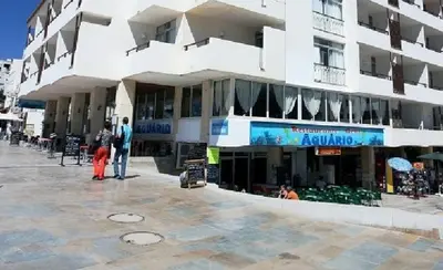 a large building with people standing outside of it at Apartamentos Edificio Albufeira - Alojamento Local in Albufeira
