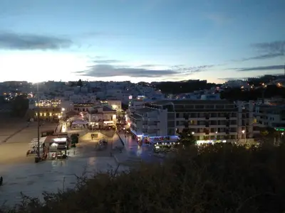 a view of a city at night with lights at Apartamentos Edificio Albufeira - Alojamento Local in Albufeira