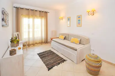a living room with a couch and a table at Bogart at Casablanca by OCvillas in Albufeira