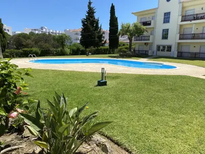 a swimming pool in a yard next to a building at Bogart at Casablanca by OCvillas in Albufeira