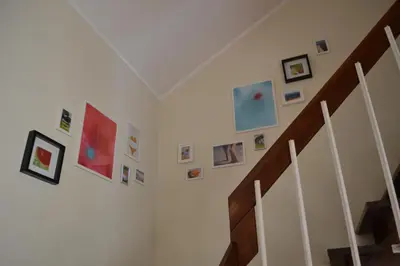 a staircase with pictures on the walls of a room at TP MARINA 27, Vilamoura View Apartment in Quarteira