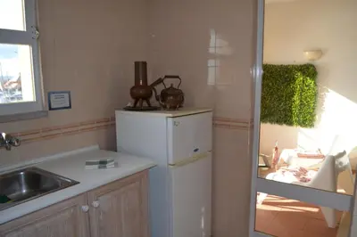 a kitchen with a white refrigerator and a sink at TP MARINA 27, Vilamoura View Apartment in Quarteira