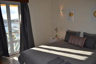 a bedroom with a bed with a view of a harbor at TP MARINA 27, Vilamoura View Apartment in Quarteira