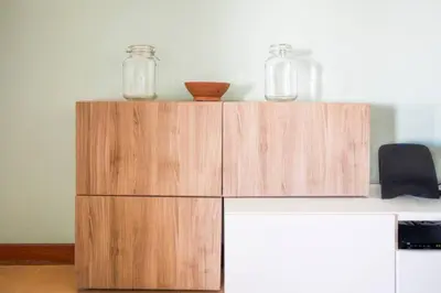 a wooden cabinet with two jars on top of it at The Albufeira Concierge - Modern Salgados in Albufeira