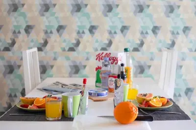 a table with two plates of oranges and drinks at The Albufeira Concierge - Modern Salgados in Albufeira