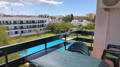 a balcony with a bench and a view of a building at Hello Sun in Vilamoura