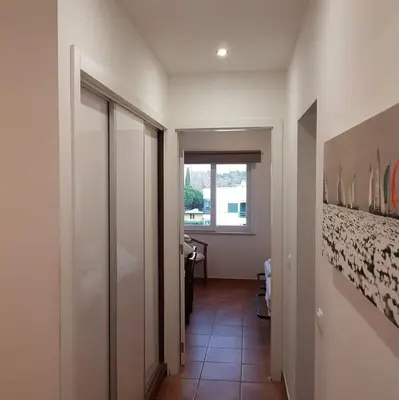 a hallway with a door to a room with a window at Hello Sun in Vilamoura