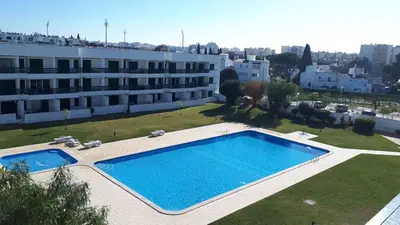 a large swimming pool in front of a building at Hello Sun in Vilamoura