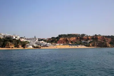a view of a beach with a town and buildings at Casa Laranjinha in Albufeira