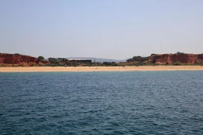 a body of water with a beach in the background at Casa Laranjinha in Albufeira