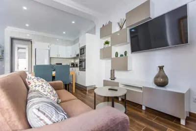 a living room with a couch and a table at Casa Laranjinha in Albufeira