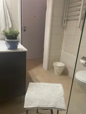 a bathroom with a sink and a toilet and a stool at Bayview Apartment 213 in Albufeira