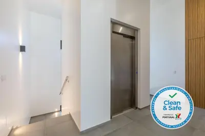 a hallway with a door and a sign in front of it at Luxury 47 in Albufeira