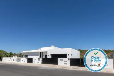 a white building with a sign in front of it at Luxury 47 in Albufeira