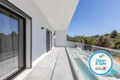 a white house with a clear and safe sign on a balcony at Luxury 47 in Albufeira