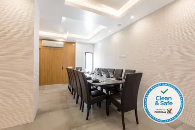 a conference room with a long table and black chairs at Luxury 47 in Albufeira