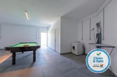 a room with a pool table and a sign for clean and safe at Luxury 47 in Albufeira