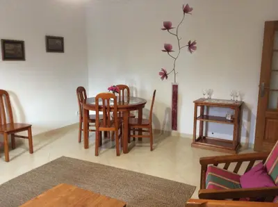 a living room with a table and chairs at Nice apartment near Faro's airport in Faro