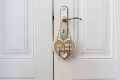 a heart shaped do not disturb sign on a door at Faro Cosy Guesthouse in Faro