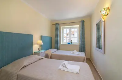 a bedroom with two beds and a window at The Old Village, Prestige and Solar by Village 4U in Vilamoura