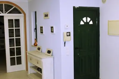 a room with a green door and a white wall at Wonderful Villa in Albufeira