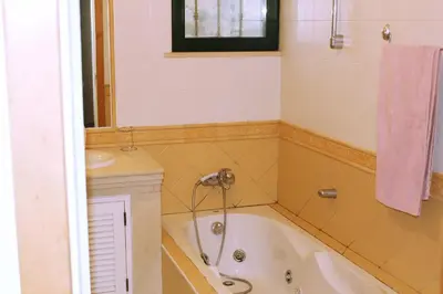 a bathroom with a tub and a sink at Wonderful Villa in Albufeira
