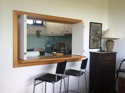 a kitchen with a counter and two stools in a room at Golf Residence Apartment in Vilamoura