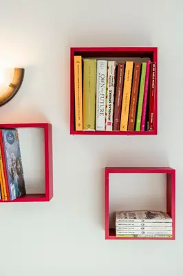 two shelves with books on a white wall at Golf Residence Apartment in Vilamoura